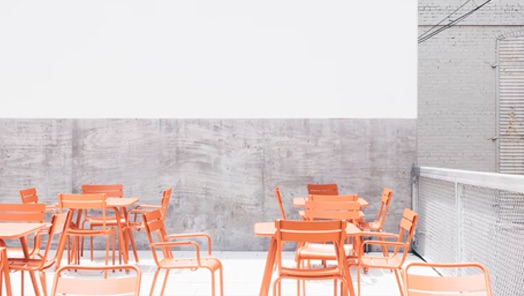 Tables and chairs setup on a concrete patio.